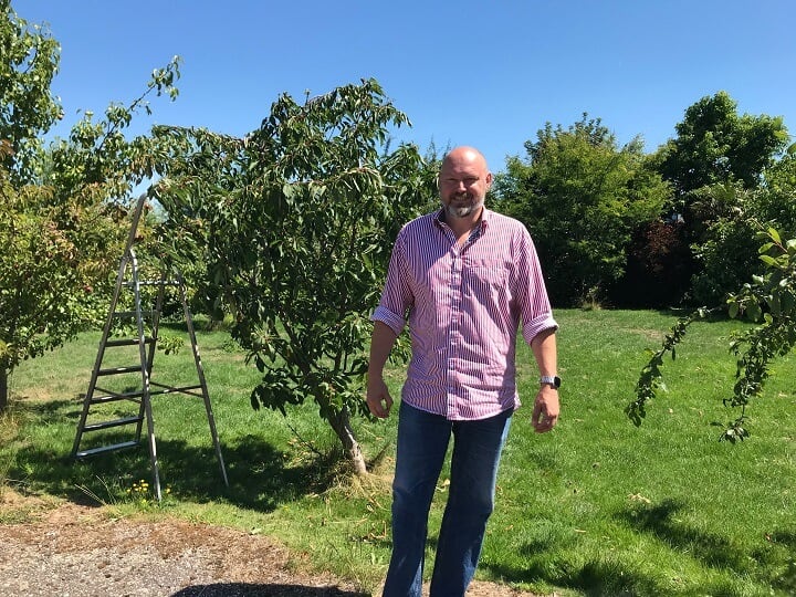 Joep Lobée poseert voor zijn fruitbomen